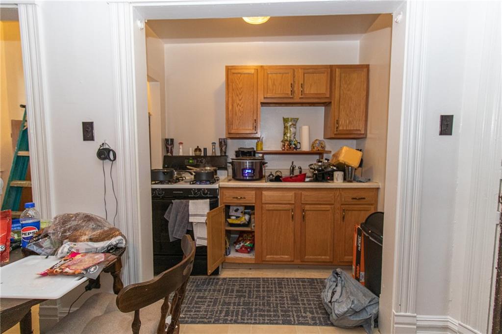 151 Margaret Street Pittsburgh, PA 15210 - Photo 24 of 36 a kitchen with a sink and a refrigerator