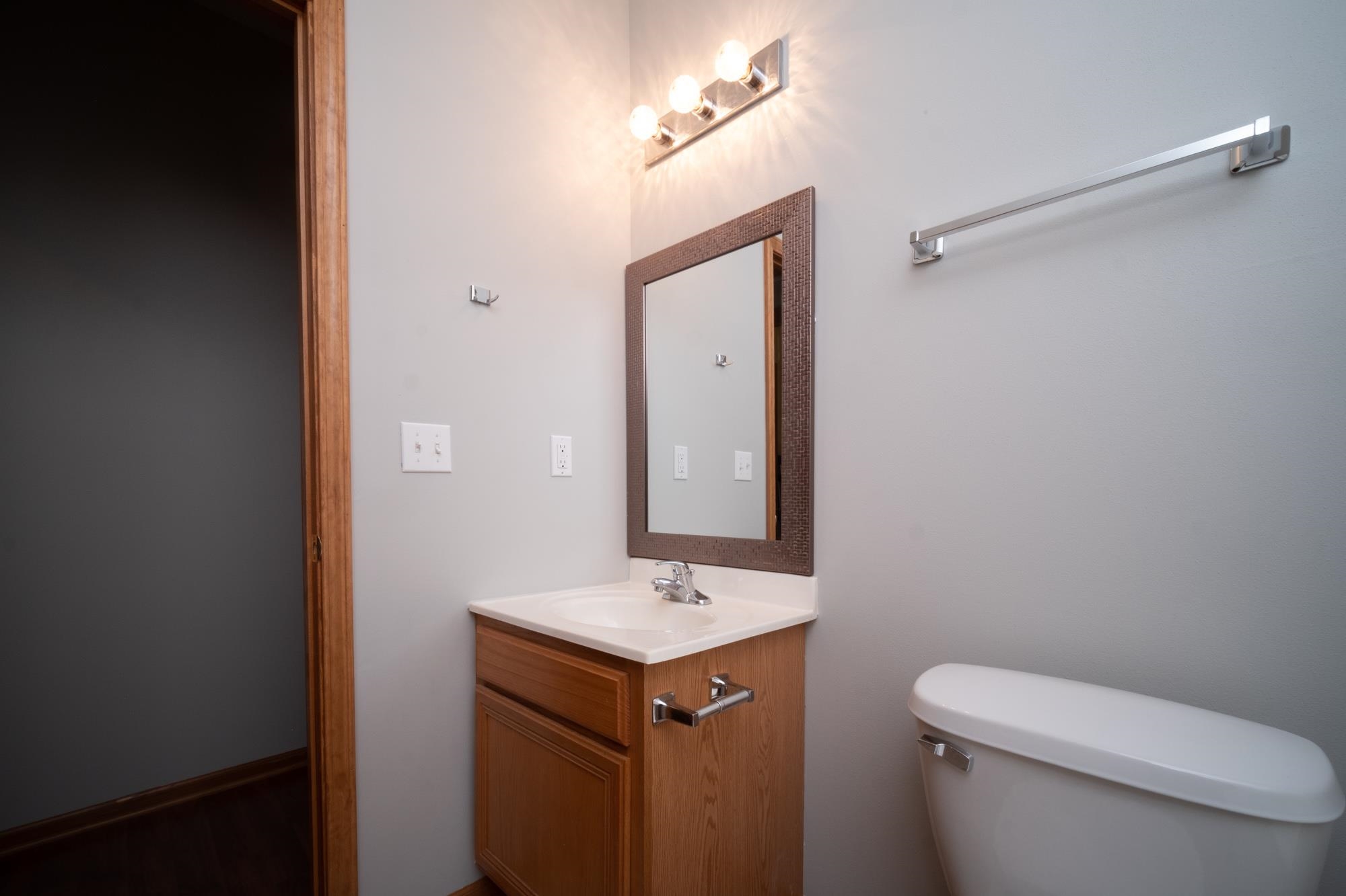 10308 Marblewing Road Roscoe, IL 61073 - Photo 18 of 26 a bathroom with a toilet sink and mirror