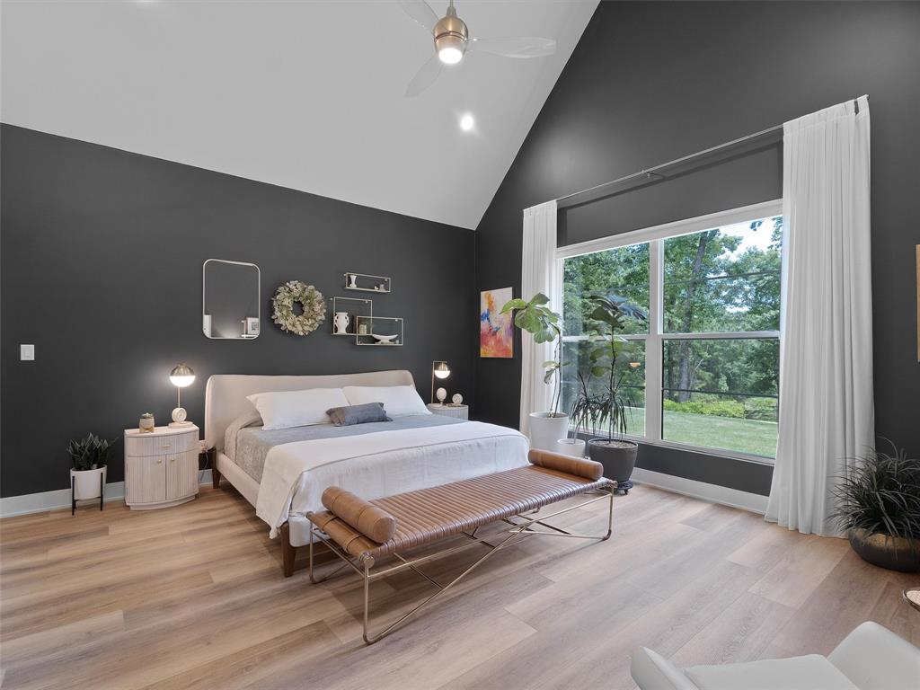 800 John Dean Road Gilmer, TX 75644 - Photo 22 of 40 a bedroom with a large bed and a large window
