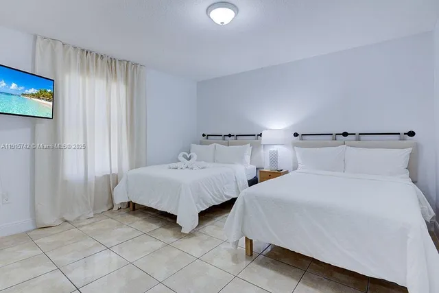 a bedroom with double bed and a night stand