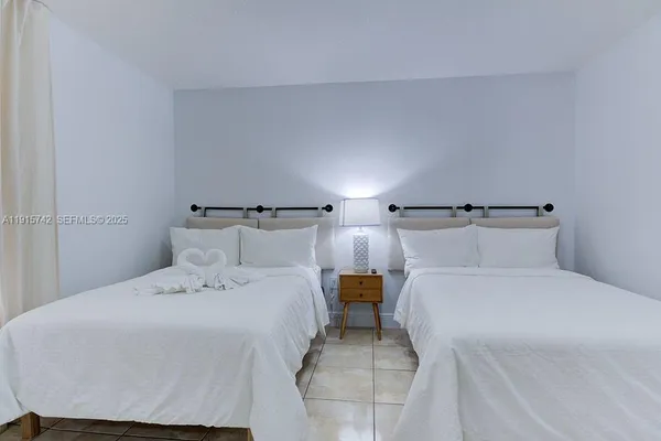 a bedroom with a bed and a view of bathroom