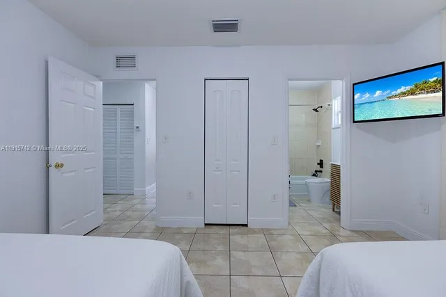 a bedroom with a bed and a view of bathroom