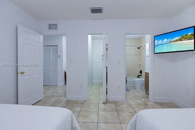 a bathroom with a glass door shower a sink and a mirror