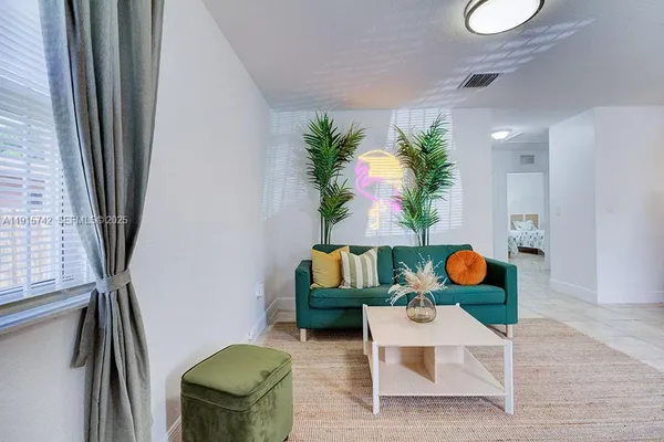 a living room with furniture and floor to ceiling window