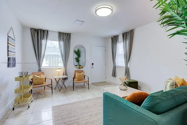 a living room with furniture and wooden floor