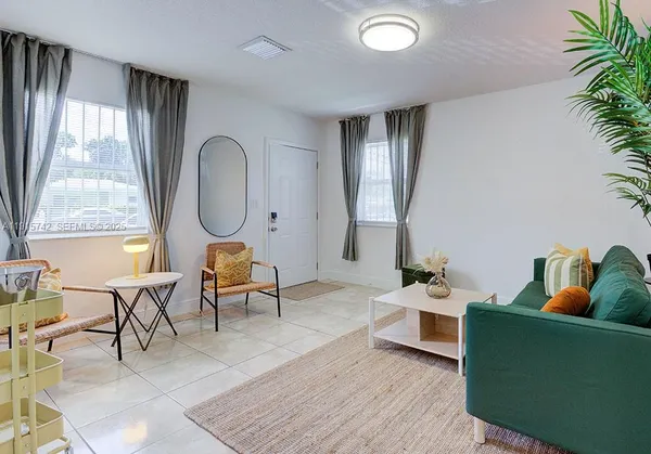 a living room filled with furniture and a window