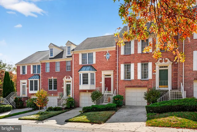 front view of a brick house with a yard