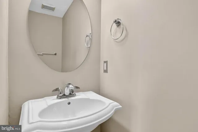 a bathroom with a sink and mirror
