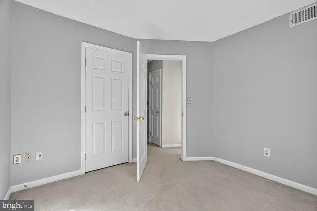 an empty room with closet area