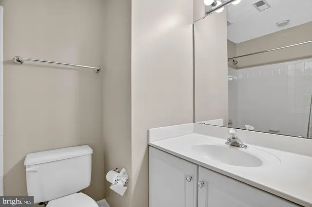 a bathroom with a toilet sink and a mirror