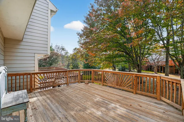 a view of deck with wooden floor and fence with a large window