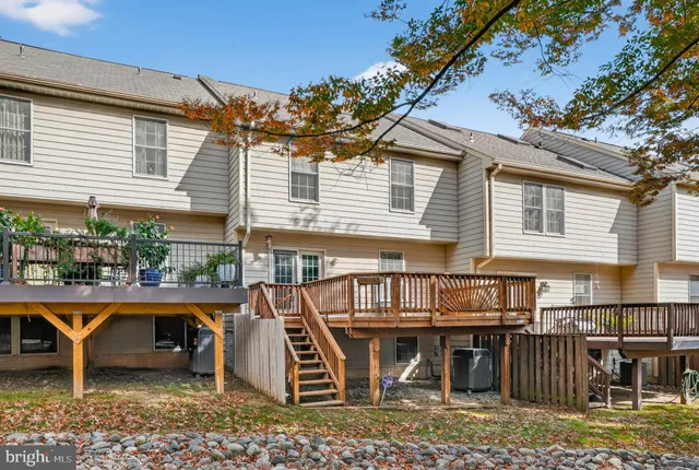 a view of a house with a wooden deck
