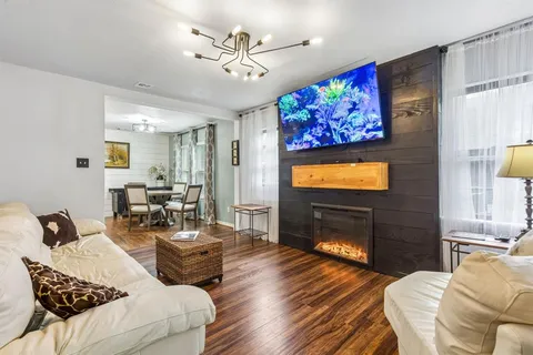 a living room with furniture and a flat screen tv