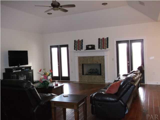 6277 Sardine Road Brewton, AL 36426 - Photo 4 of 24 Fireplace great focal point, note double doors leading out to the covered deck.