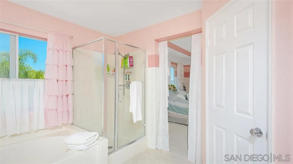 769 Avenida Codorniz San Marcos, CA 92069 - Photo 19 of 25 a bathroom with a shower and a glass door