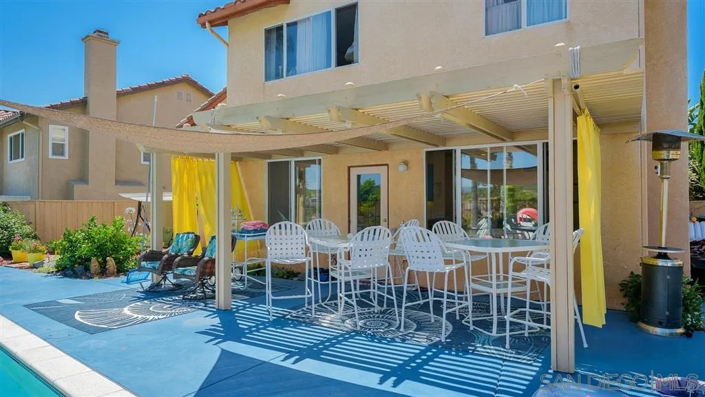 769 Avenida Codorniz San Marcos, CA 92069 - Photo 4 of 25 a view of a patio with table and chairs potted plants and floor to ceiling window
