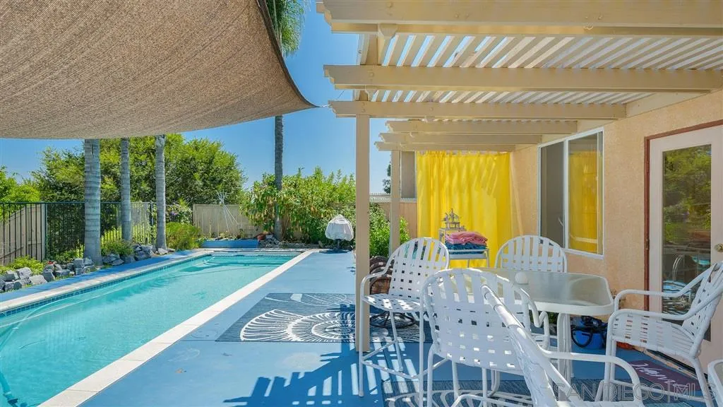 769 Avenida Codorniz San Marcos, CA 92069 - Photo 5 of 25 a view of a patio with table and chairs potted plants and floor to ceiling window