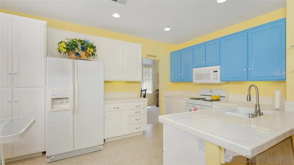 769 Avenida Codorniz San Marcos, CA 92069 - Photo 10 of 25 a kitchen with a sink a stove and cabinets
