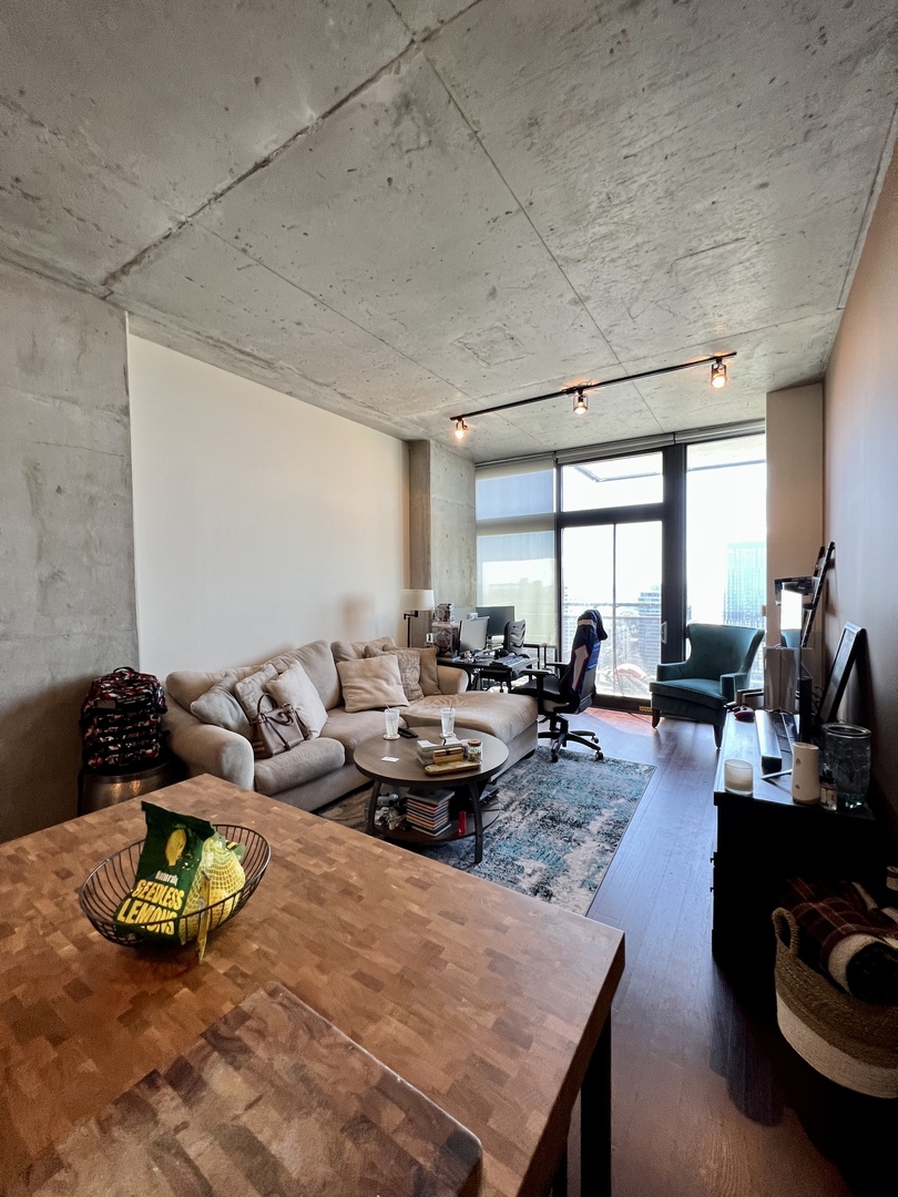 235 West Van Buren Street, Unit 3310 Chicago, IL 60607 - Photo 7 of 18 a living room with furniture and a wooden floor