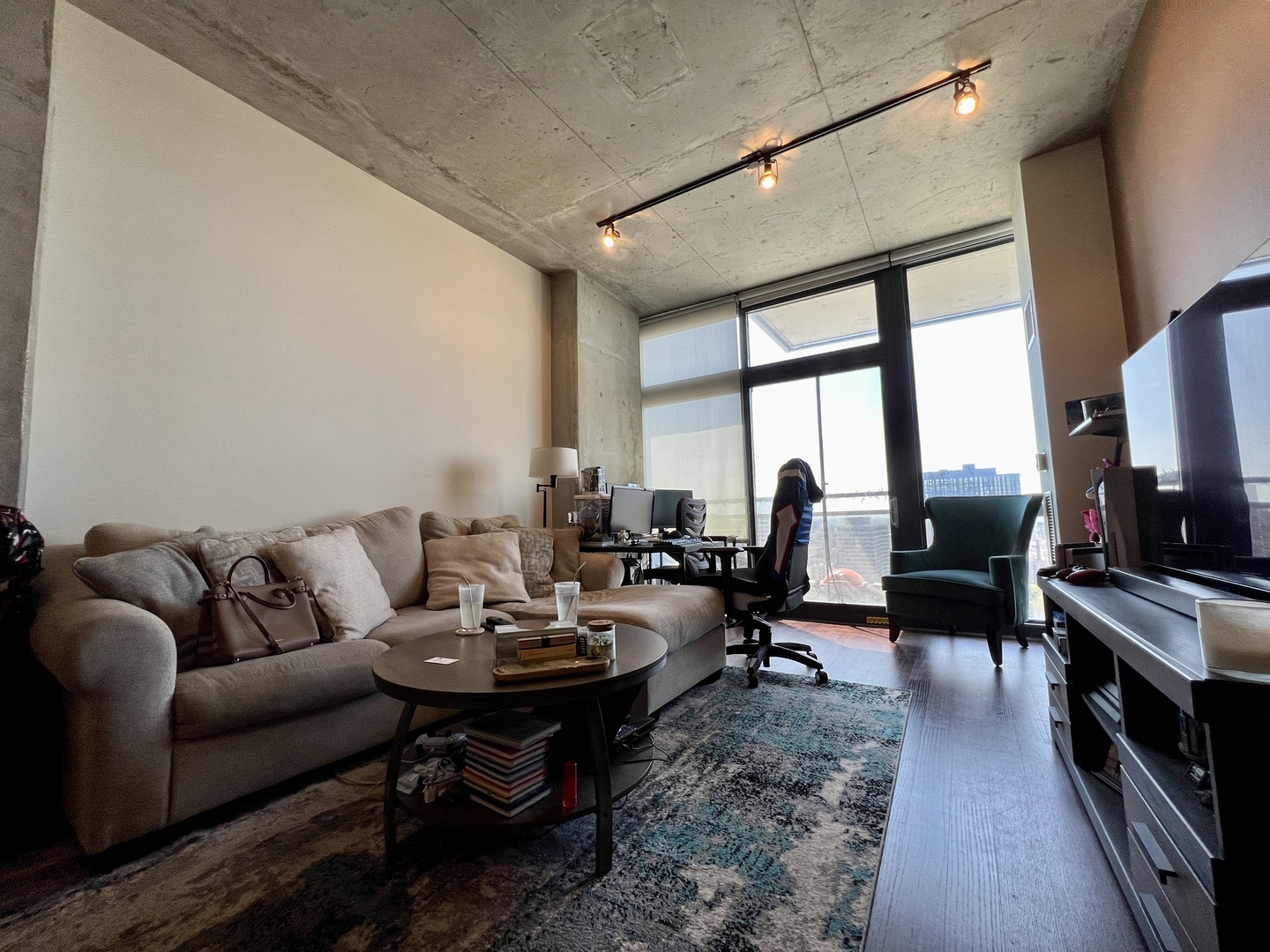 235 West Van Buren Street, Unit 3310 Chicago, IL 60607 - Photo 8 of 18 a living room with furniture flat screen tv and a large window