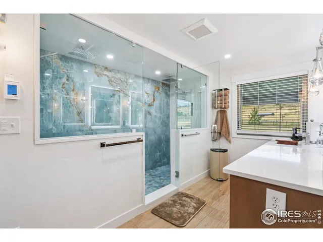 a bathroom with a sink a large mirror and a shower