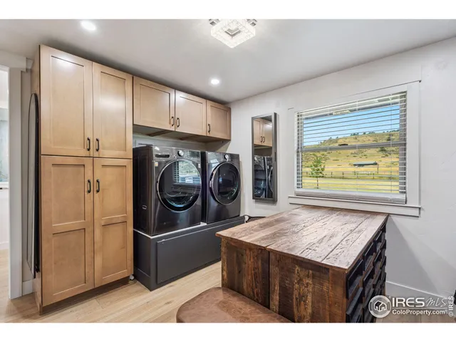 a kitchen with stainless steel appliances granite countertop a refrigerator a stove and a sink
