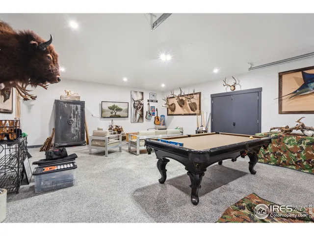 a living room with furniture pool and a flat screen tv