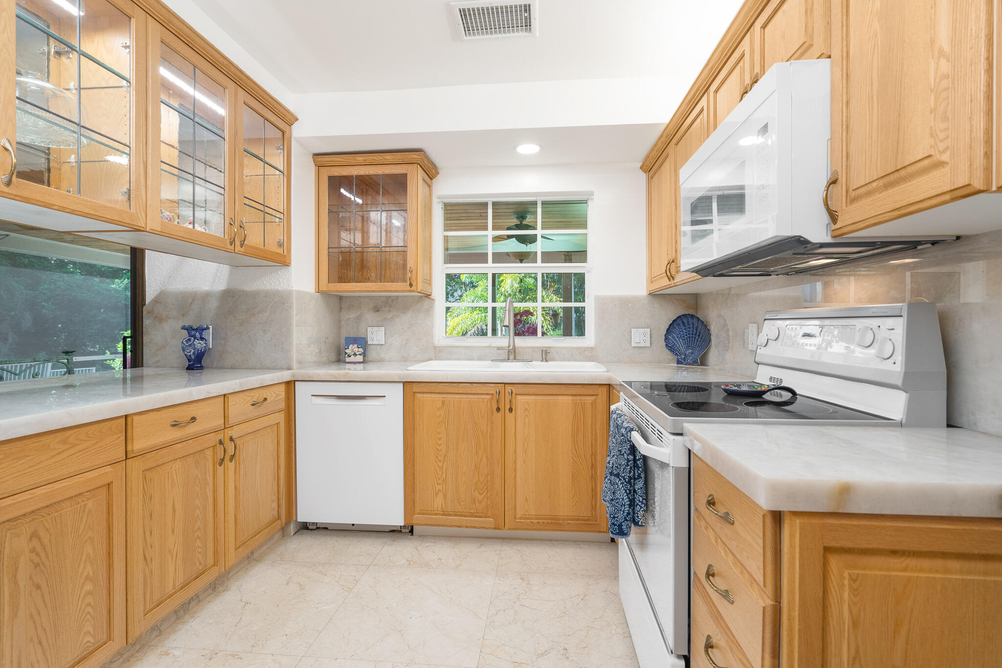 8 Northwest 24th Street Delray Beach, FL 33444 - Photo 12 of 29 a kitchen with stainless steel appliances granite countertop a stove a sink and a microwave