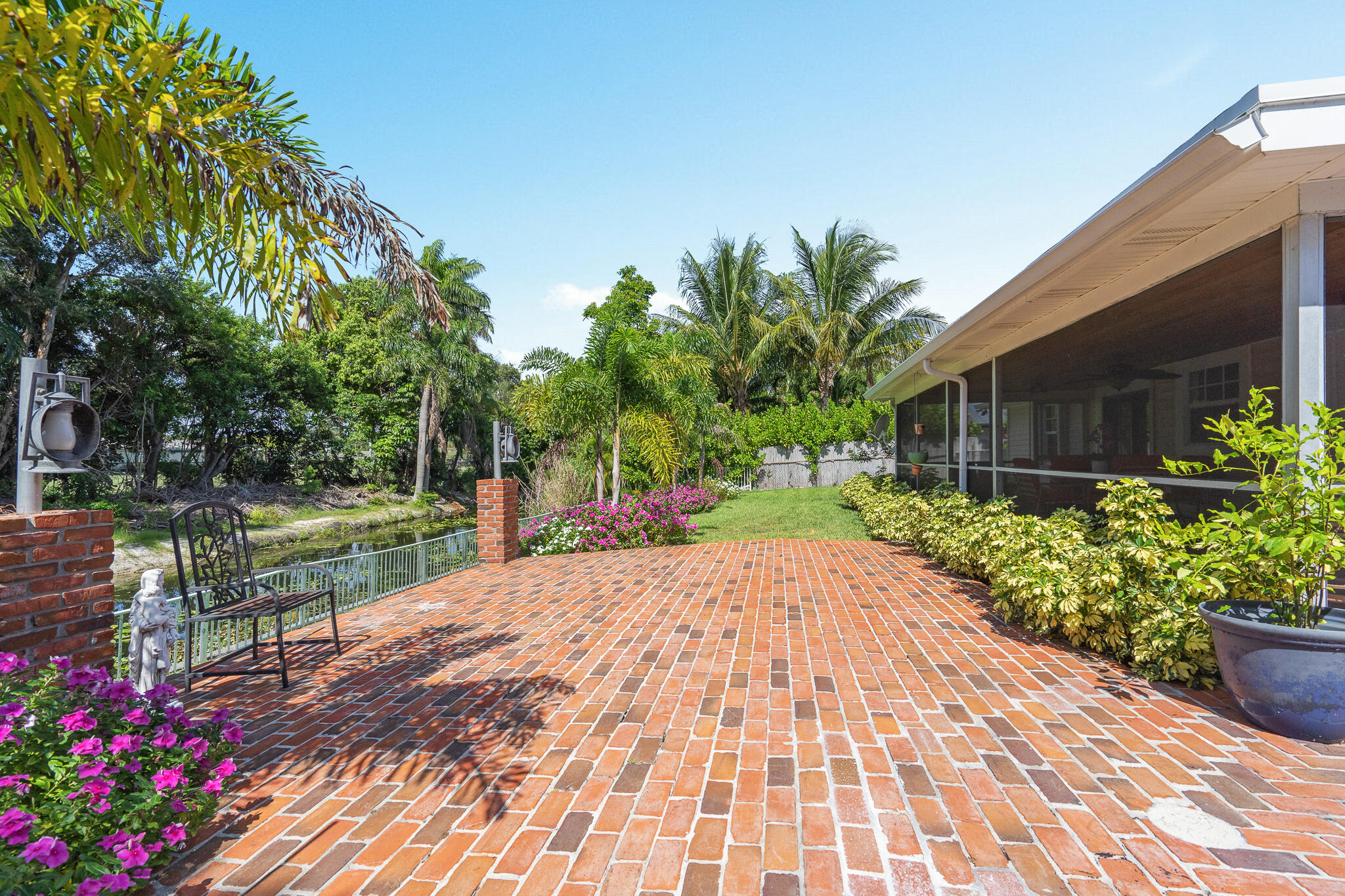 8 Northwest 24th Street Delray Beach, FL 33444 - Photo 29 of 29 a view of a backyard with potted plants and a bench