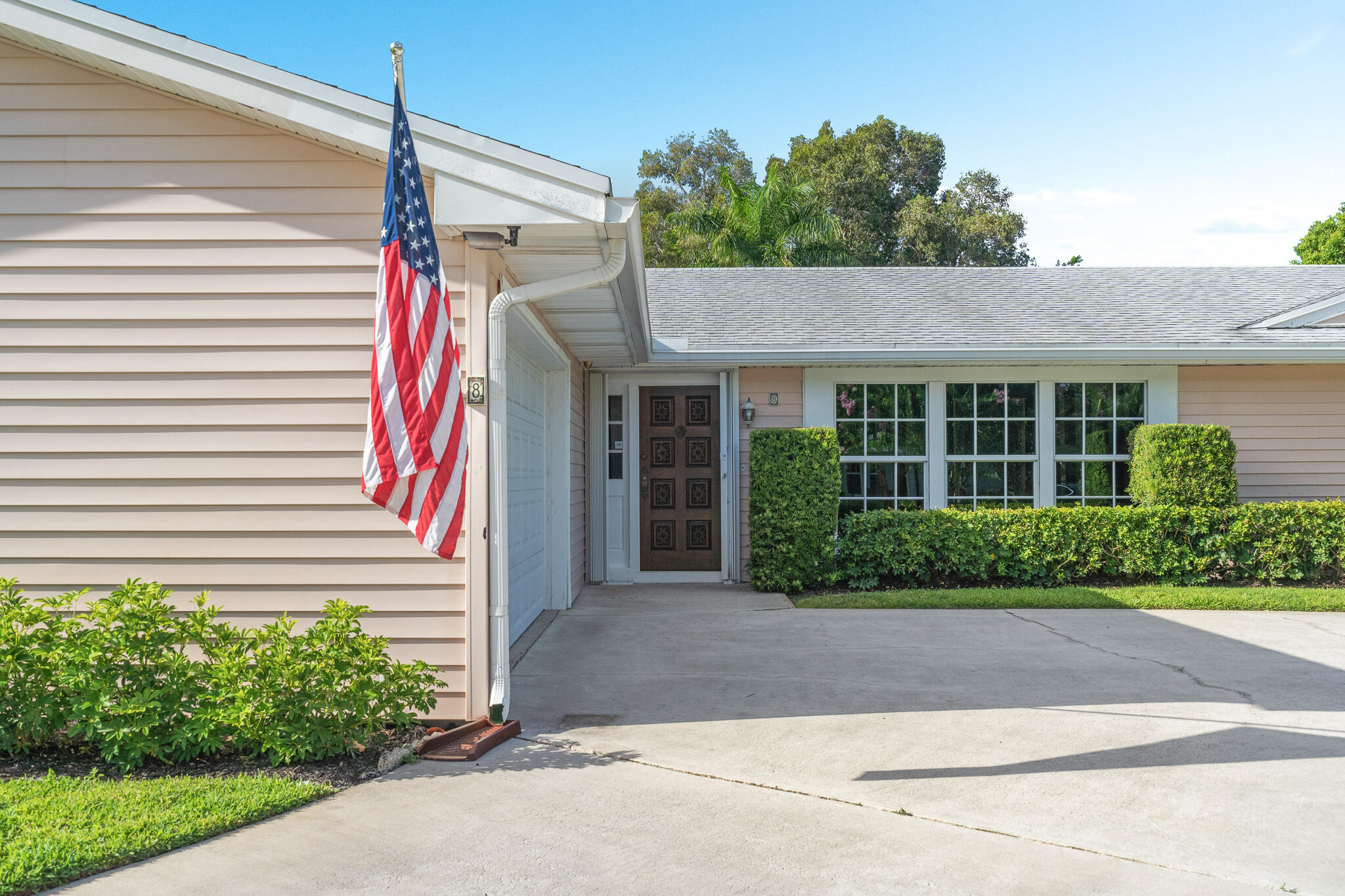 8 Northwest 24th Street Delray Beach, FL 33444 - Photo 3 of 29 a front view of a house with a yard and potted plants