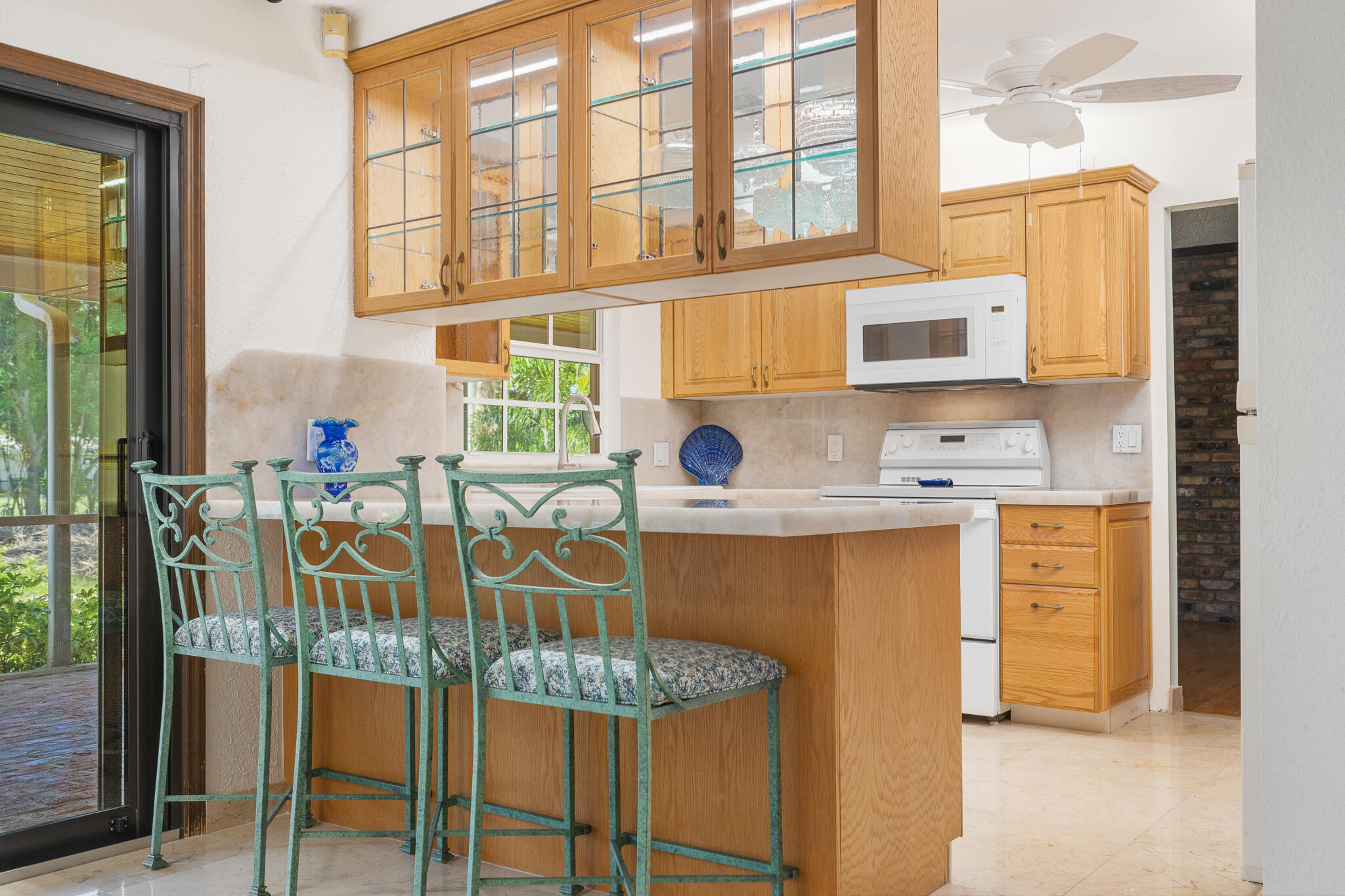 8 Northwest 24th Street Delray Beach, FL 33444 - Photo 10 of 29 a dining table chair next to a window with kitchen view