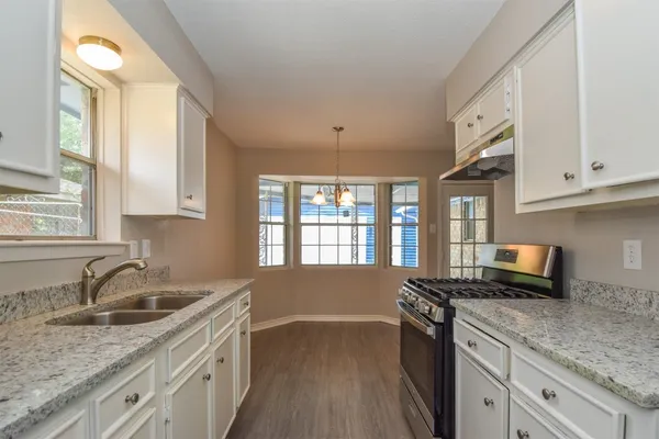 a kitchen that has a sink and a stove