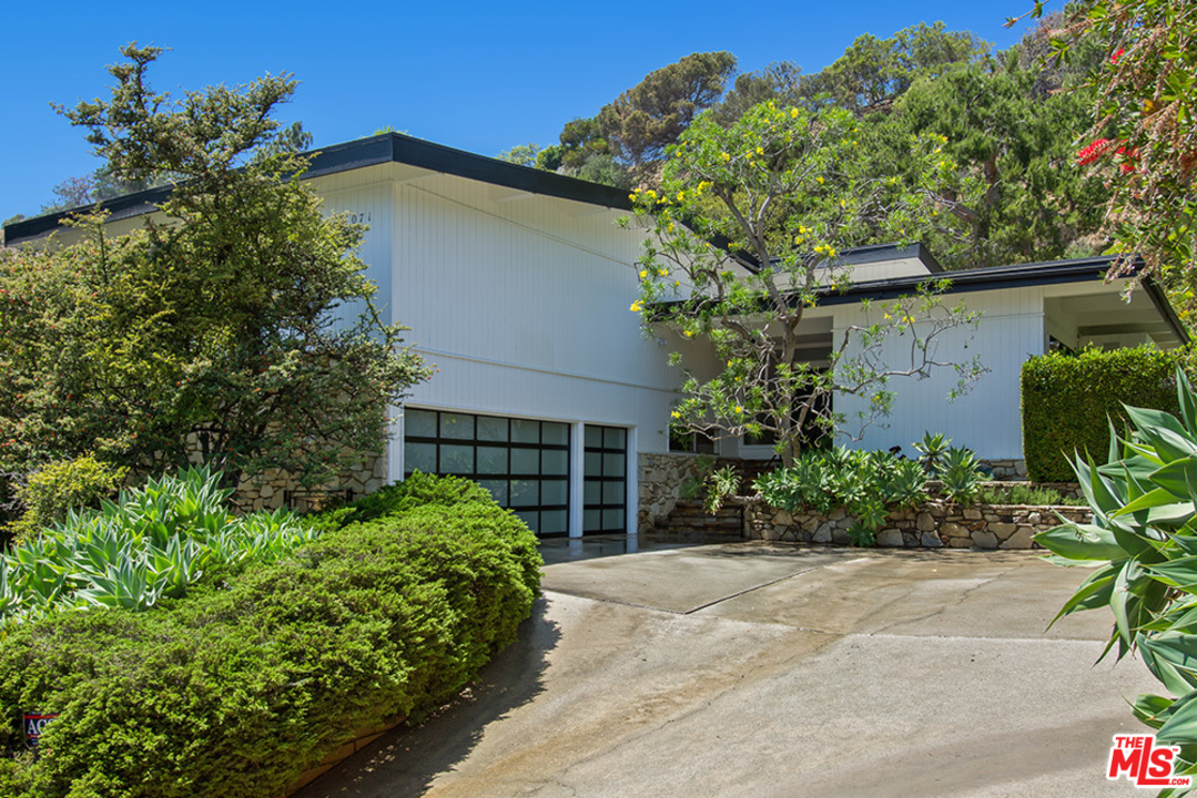 a house with a tree in front of it