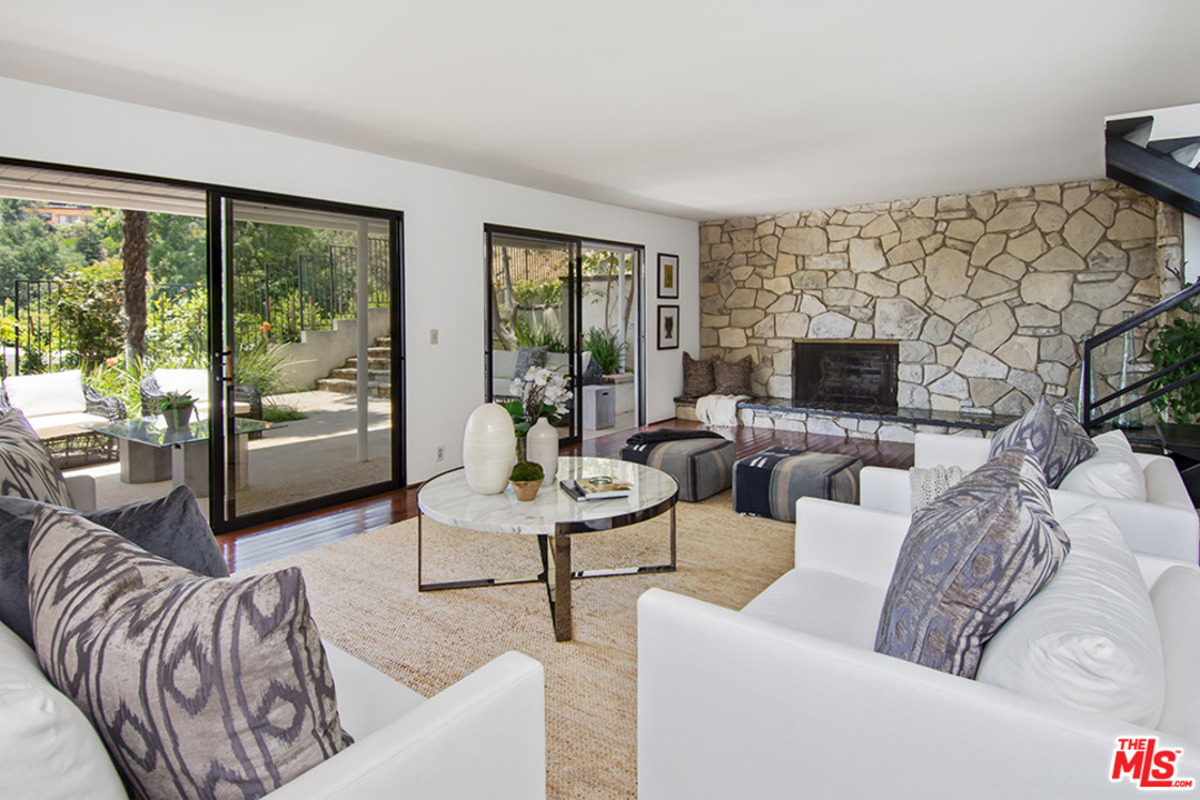 1071 Tellem Drive Pacific Palisades, CA 90272 - Photo 2 of 26 a living room with furniture and a fireplace