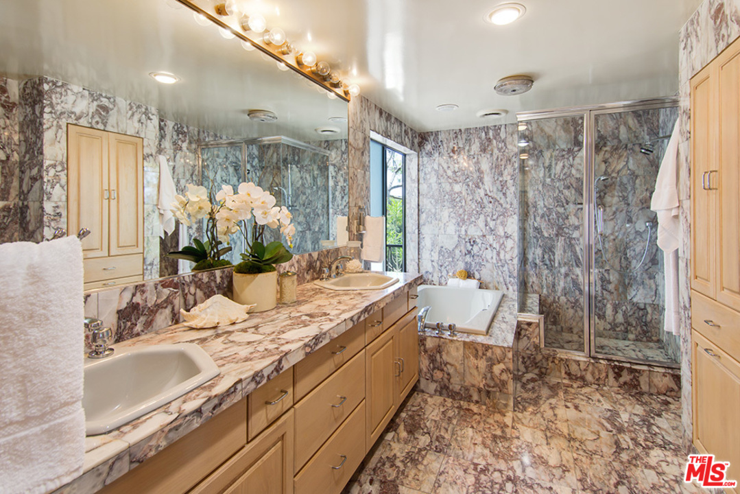 1071 Tellem Drive Pacific Palisades, CA 90272 - Photo 13 of 26 a bathroom with a granite countertop sink a toilet and shower