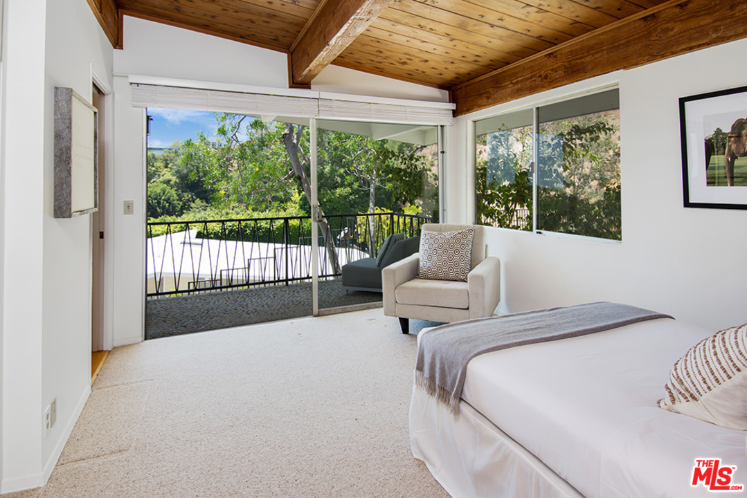 1071 Tellem Drive Pacific Palisades, CA 90272 - Photo 14 of 26 a bedroom with furniture and a large window