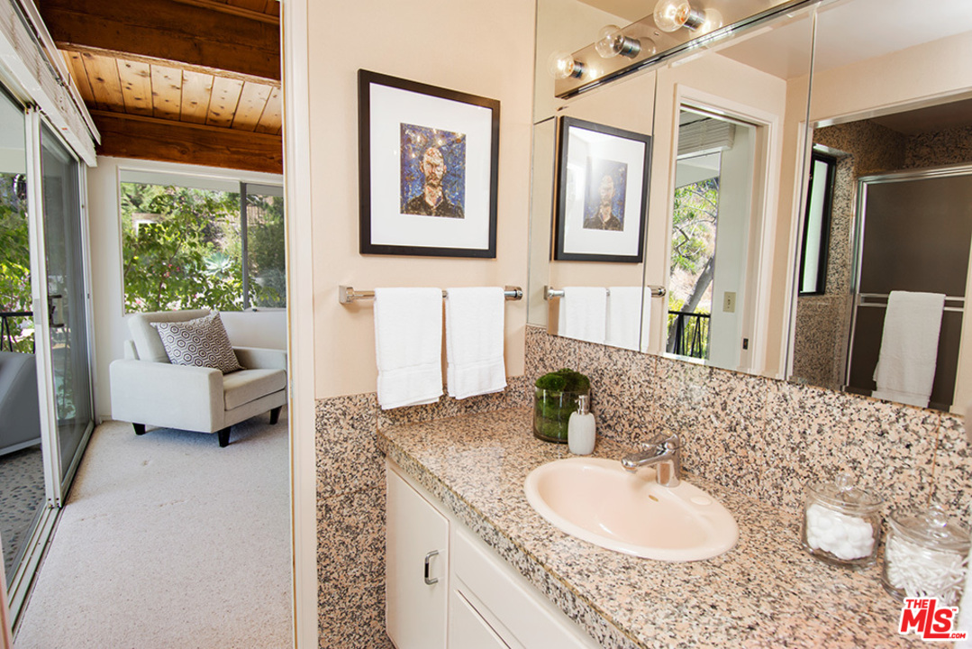 1071 Tellem Drive Pacific Palisades, CA 90272 - Photo 15 of 26 a bathroom with a granite countertop sink and a mirror
