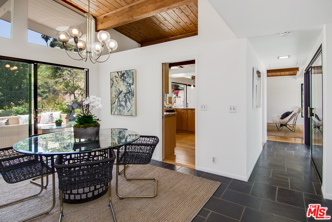 1071 Tellem Drive Pacific Palisades, CA 90272 - Photo 4 of 26 a living room with furniture a chandelier and a dining table
