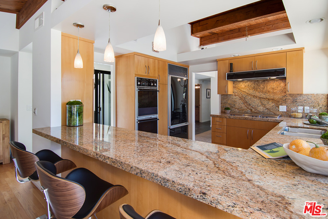 1071 Tellem Drive Pacific Palisades, CA 90272 - Photo 7 of 26 a room with wooden floor and furniture