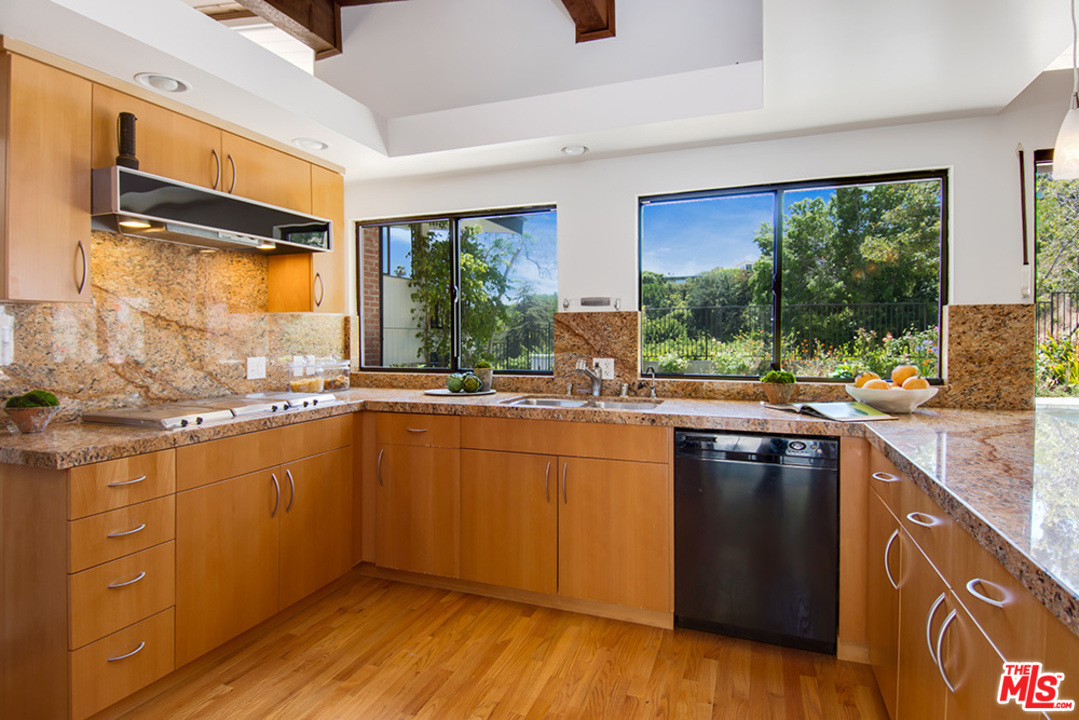 1071 Tellem Drive Pacific Palisades, CA 90272 - Photo 8 of 26 a kitchen with stainless steel appliances granite countertop a stove a sink and a refrigerator