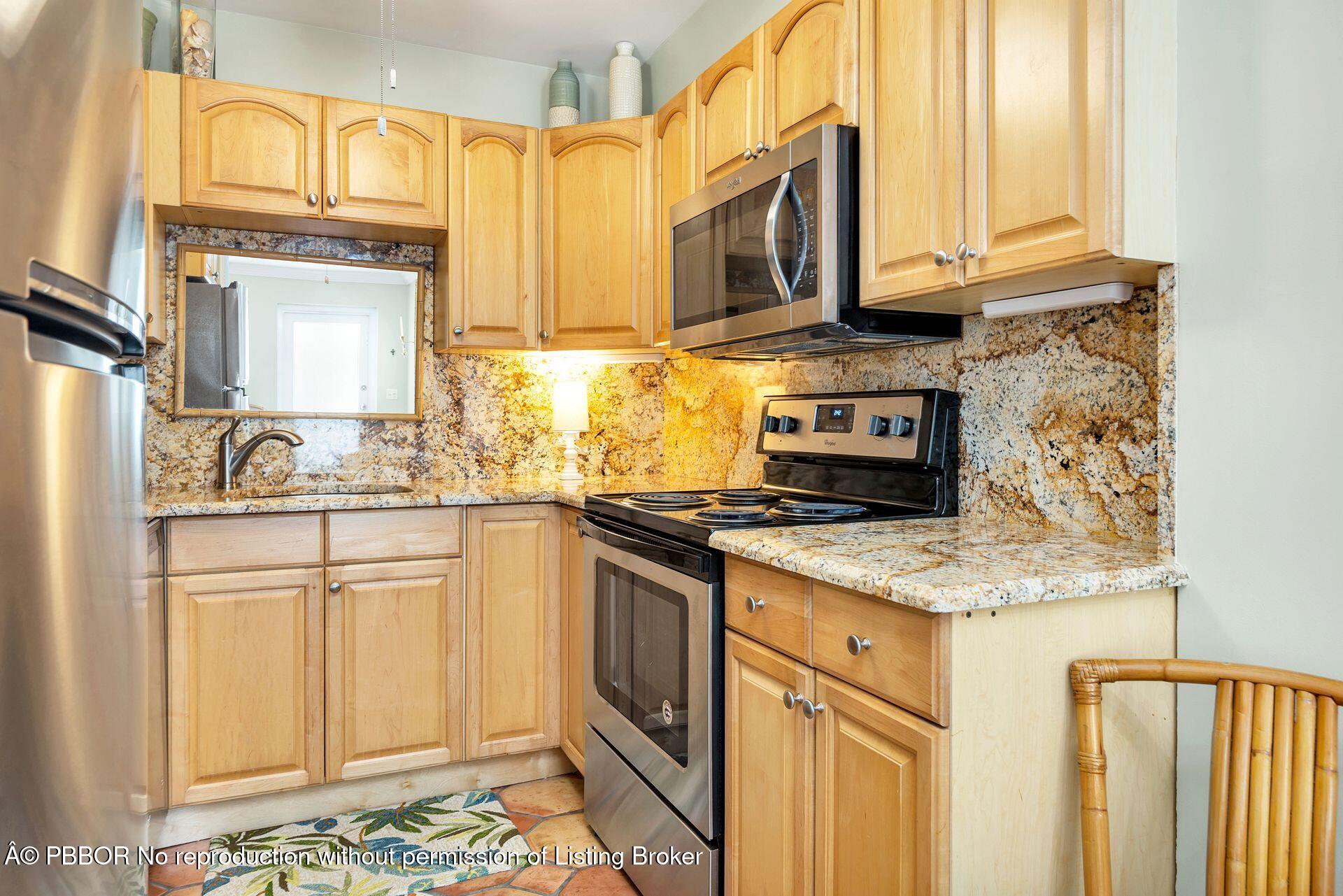 401 Peruvian Avenue, Unit 1050 Palm Beach, FL 33480 - Photo 5 of 17 a kitchen with stainless steel appliances granite countertop a stove a sink and a microwave