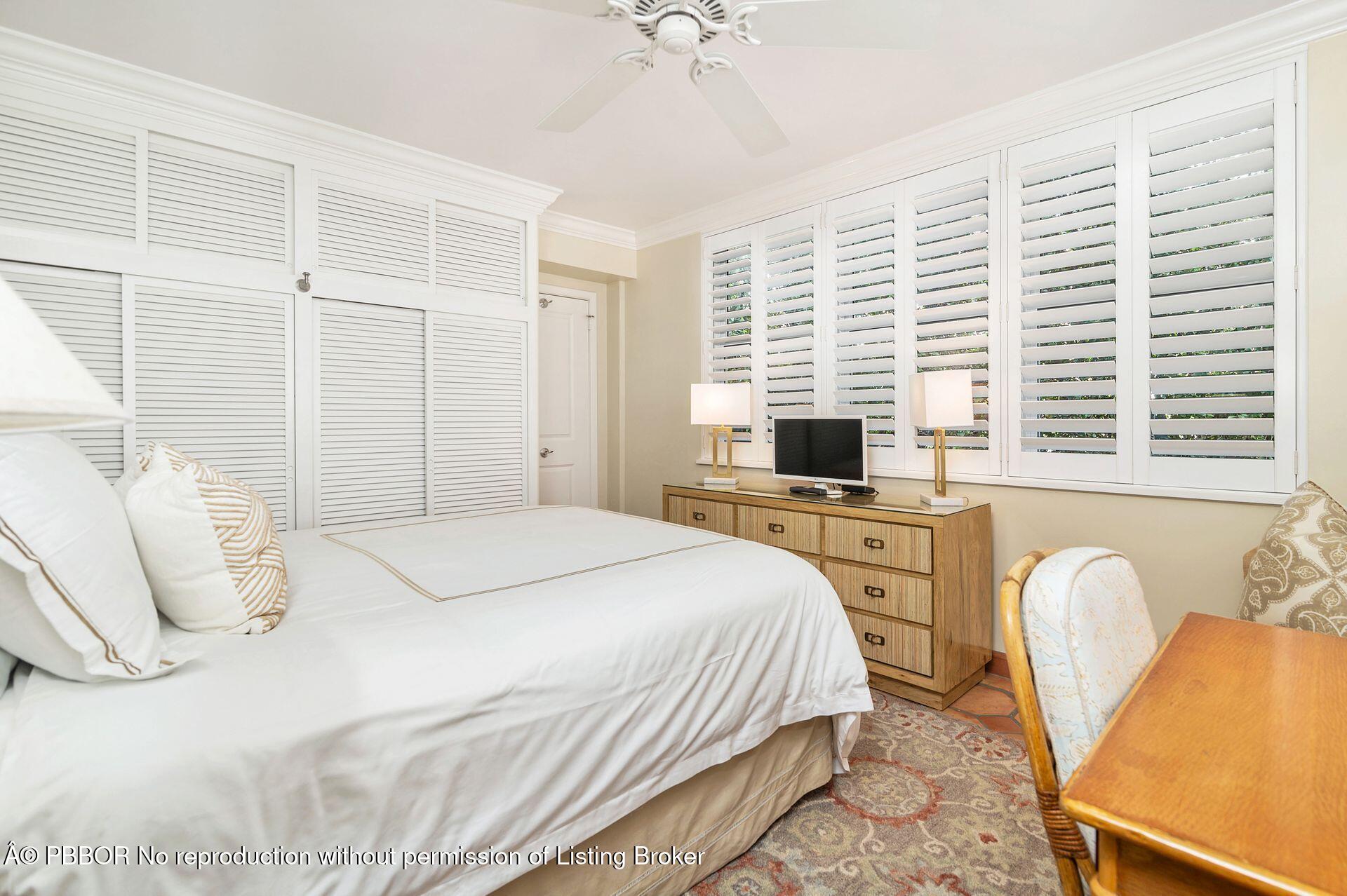401 Peruvian Avenue, Unit 1050 Palm Beach, FL 33480 - Photo 8 of 17 a bedroom with a bed a computer on the desk and a stove