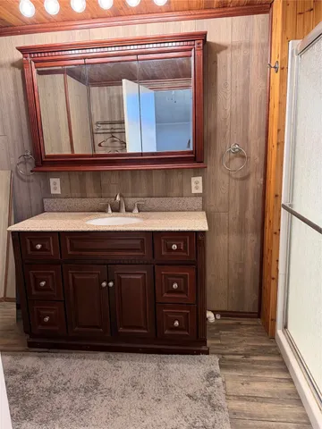 a bathroom with a granite countertop sink toilet and shower