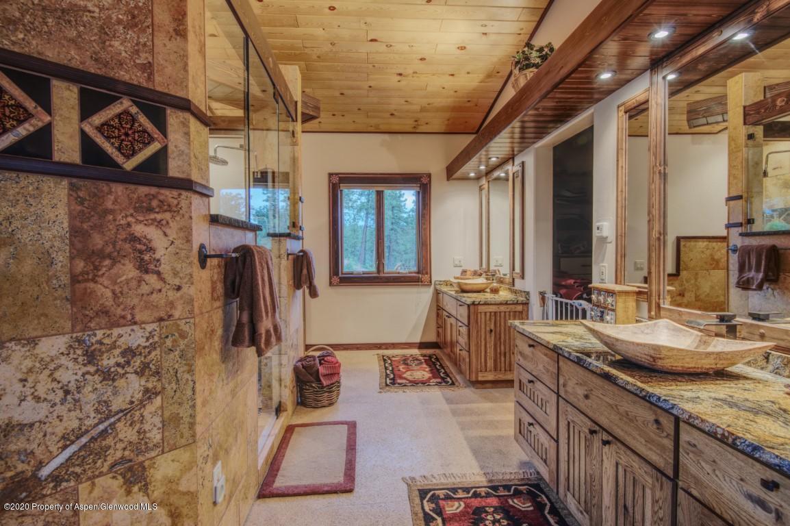 1350 Rincon Ridge Road Durango, CO 81301 - Photo 17 of 48 a bathroom with double vanity and a shower