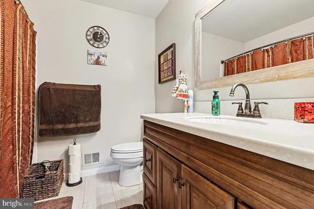 a bathroom with a sink toilet and a mirror