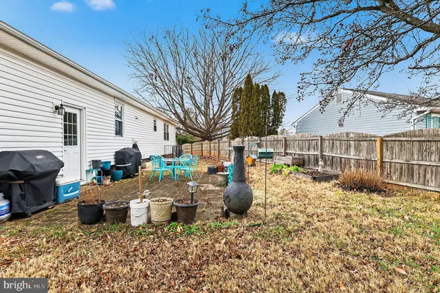 a view of a patio with barbeque grill and couches