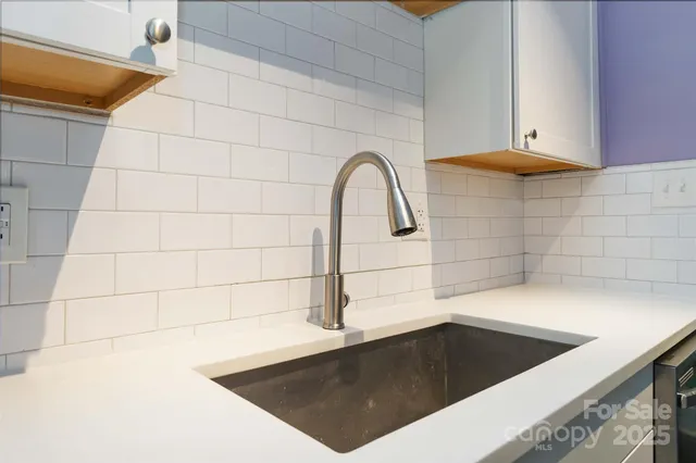 a kitchen with stainless steel appliances a stove a microwave and a refrigerator