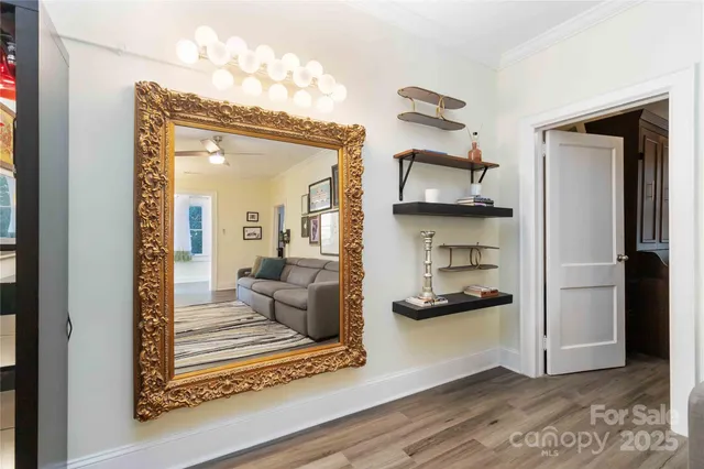 a view of a room with wooden floor and a window