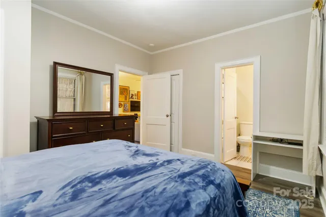 a view of a hallway with wooden floor and windows