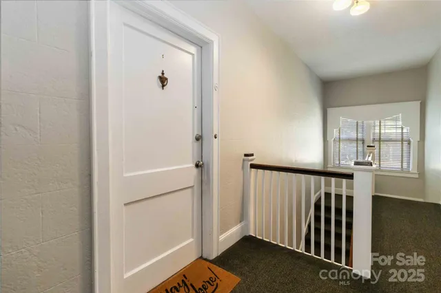 a front view of house and yard with beautiful flowers and green space